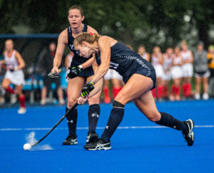 A Yale field hockey player strikes the ball in a game at Johnson Field