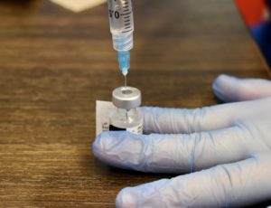 A healthcare worker draws a dose of the COVID-19 vaccine.